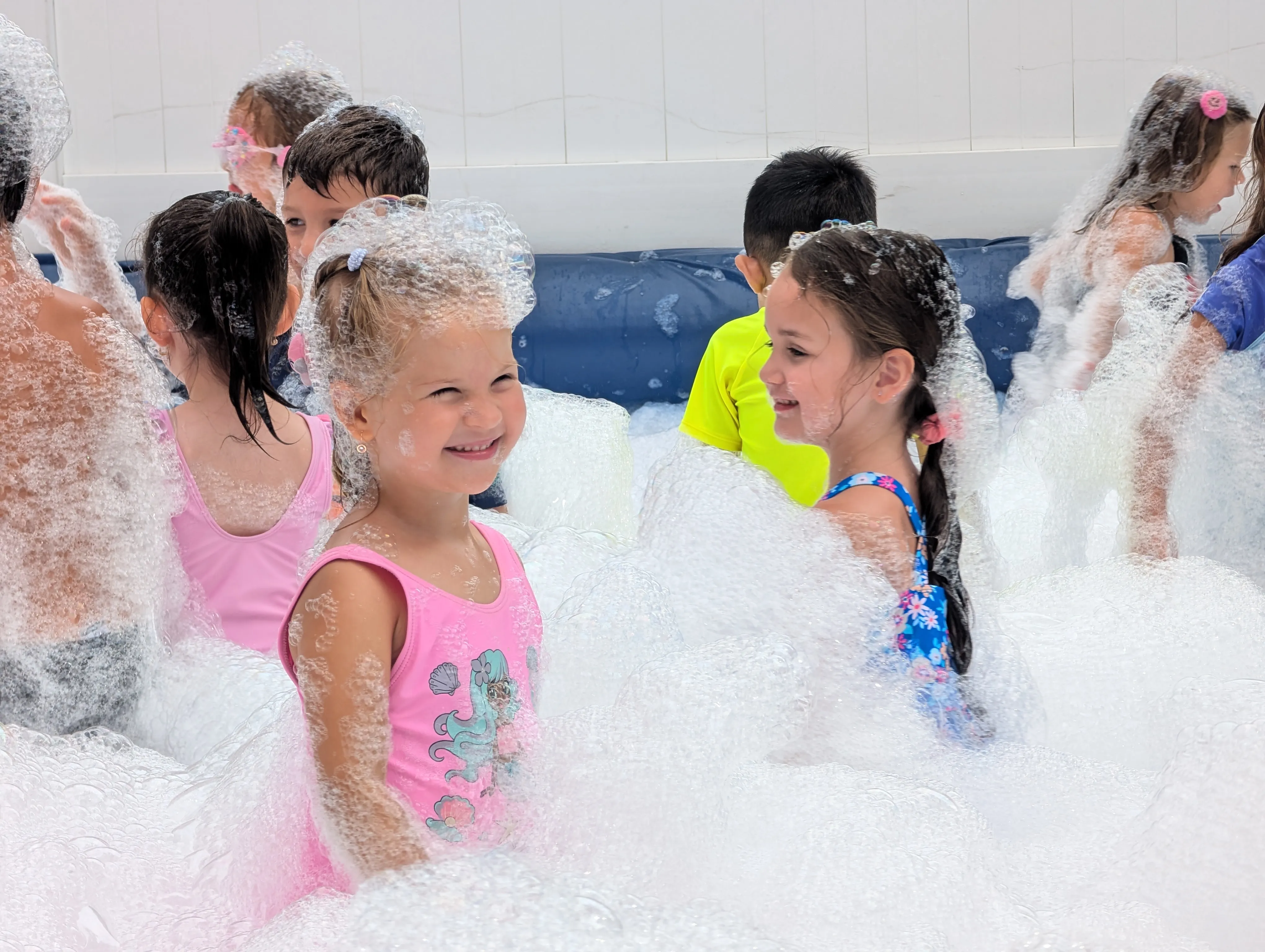 Children playing together in outdoor party foam